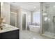 Bathroom featuring double doors, a modern shower, soaking tub, and stylish sink with marble countertop at 1253 Lucile Sw Ave, Atlanta, GA 30310