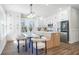 Modern kitchen features white cabinets, stainless steel appliances, an island, and an adjacent dining area at 1253 Lucile Sw Ave, Atlanta, GA 30310