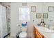 Bathroom featuring a toilet, vanity with sink, and framed novelty art at 2951 N Mckoy Rd, Villa Rica, GA 30180