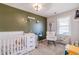 Well-appointed Bedroom with crib, changing table, rocking chair, and thoughtful decorations at 2951 N Mckoy Rd, Villa Rica, GA 30180