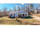 Inviting single-story home featuring a covered front porch with seating, complemented by a well-maintained lawn at 2951 N Mckoy Rd, Villa Rica, GA 30180