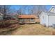 Rustic storage shed with a red roof nestled on a grassy slope near the main house at 2951 N Mckoy Rd, Villa Rica, GA 30180