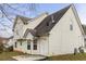 Back of two-story home with a concrete pad, and a partial view of yard at 3958 Waldrop Hills Dr, Decatur, GA 30034