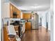 Kitchen featuring stainless steel appliances, wooden cabinets, and laminate floors at 3958 Waldrop Hills Dr, Decatur, GA 30034