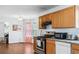 Kitchen featuring stainless steel appliances, wooden cabinets, and access to laundry room at 3958 Waldrop Hills Dr, Decatur, GA 30034