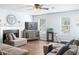 Relaxing living room featuring hardwood flooring, a ceiling fan, and natural light streaming through the windows at 3958 Waldrop Hills Dr, Decatur, GA 30034