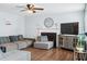 Comfortable living room featuring a decorative fireplace, ceiling fan, and hardwood flooring at 3958 Waldrop Hills Dr, Decatur, GA 30034