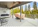 Covered back deck features outdoor furniture, a ceiling fan, and a serene wooded view at 624 Hemlock Trl, Canton, GA 30114