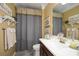 Well-lit bathroom with a vanity, mirror, and a shower/tub combination at 624 Hemlock Trl, Canton, GA 30114