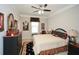 Tastefully decorated bedroom with a ceiling fan, dresser, nightstand, and large bed at 624 Hemlock Trl, Canton, GA 30114