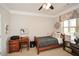 Cozy bedroom with a ceiling fan, desk, and a window that provides natural lighting at 624 Hemlock Trl, Canton, GA 30114