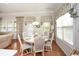 Light-filled breakfast nook with a round table, stylish chairs, and charming decor at 624 Hemlock Trl, Canton, GA 30114