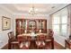 Elegant dining room with hardwood floors, chandelier, and a large wooden china cabinet at 624 Hemlock Trl, Canton, GA 30114