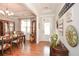 Elegant dining room with hardwood floors, tray ceiling, and a large wooden china cabinet at 624 Hemlock Trl, Canton, GA 30114