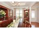 Formal dining room featuring a large wood table, china cabinet, and decorative accents at 624 Hemlock Trl, Canton, GA 30114