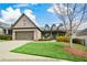 Charming brick home with a well-manicured lawn, attached two-car garage and covered front porch at 624 Hemlock Trl, Canton, GA 30114