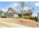 Charming brick home with a dormant lawn, attached two-car garage and covered front porch at 624 Hemlock Trl, Canton, GA 30114