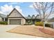 Charming brick home with a dormant lawn, attached two-car garage and covered front porch at 624 Hemlock Trl, Canton, GA 30114