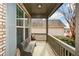 Covered front porch with wooden bench seating and view to a neighboring home at 624 Hemlock Trl, Canton, GA 30114