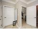 Hallway with neutral tones with two doors and a view into the bedroom at 624 Hemlock Trl, Canton, GA 30114