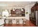 Spacious kitchen with stainless steel refrigerator, large island and dark wood cabinets at 624 Hemlock Trl, Canton, GA 30114