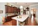 Kitchen boasts a large island, modern appliances, dark wood cabinets, and brick backsplash at 624 Hemlock Trl, Canton, GA 30114