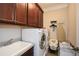 Well-equipped laundry room with a sink, washer, dryer, and ample storage at 624 Hemlock Trl, Canton, GA 30114