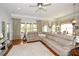 Bright and airy living room featuring a large sectional sofa, hardwood floors, and multiple windows at 624 Hemlock Trl, Canton, GA 30114