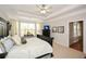 Bright main bedroom with a dark wood furniture set, large windows, a ceiling fan and a view to the next room at 624 Hemlock Trl, Canton, GA 30114