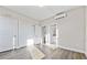 Serene bedroom featuring two closets, neutral walls, and durable gray wood floors at 697 Fayetteville Rd # 303, Atlanta, GA 30316