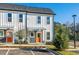 Charming townhome featuring a stylish exterior, landscaped front yard, and a vibrant orange front door at 697 Fayetteville Rd # 303, Atlanta, GA 30316