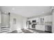 Bright and airy kitchen featuring white cabinetry, stainless steel appliances, and durable gray wood floors at 697 Fayetteville Rd # 303, Atlanta, GA 30316