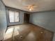 Bedroom featuring a standard closet, a ceiling fan, and ample natural light through a large window at 708 Raven Springs Trl, Stone Mountain, GA 30087