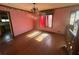 Bright dining room with hardwood floors, large window, and adjacent kitchen entrance at 708 Raven Springs Trl, Stone Mountain, GA 30087