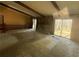 Open living room with exposed beam ceiling, stone fireplace, and sliding glass doors to the backyard at 708 Raven Springs Trl, Stone Mountain, GA 30087