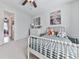 Neutral bedroom features a twin bed, a ceiling fan, a dresser, and a sunny window at 1037 Towne Mill Xing, Canton, GA 30114