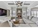 Cozy living room featuring stone fireplace, coffered ceilings, and large sectional sofa at 1037 Towne Mill Xing, Canton, GA 30114