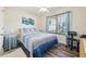 Bright bedroom featuring blue bedding, a ceiling fan, and large window for natural light at 509 Chestnut Oak Dr, Palmetto, GA 30268