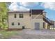View of the home's rear exterior showcasing upper level deck and lower level garage access at 509 Chestnut Oak Dr, Palmetto, GA 30268