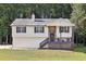 Charming split-level home with a covered front porch and well-maintained lawn at 509 Chestnut Oak Dr, Palmetto, GA 30268