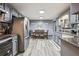 Well-lit kitchen with gray cabinets, dining area, and modern appliances at 509 Chestnut Oak Dr, Palmetto, GA 30268