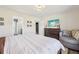 Bright main bedroom featuring an en suite bathroom, wall-mounted TV and a comfortable seating area at 509 Chestnut Oak Dr, Palmetto, GA 30268