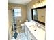 Cozy bathroom with tub, shower, vanity, and patterned floor, offering comfort and style at 625 Huiet Dr, Mcdonough, GA 30252
