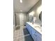 Bright bathroom featuring double sink vanity with modern fixtures and decorative patterned floors at 625 Huiet Dr, Mcdonough, GA 30252