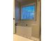 Relaxing bathtub area with a tiled backsplash and a window bringing in natural light at 625 Huiet Dr, Mcdonough, GA 30252