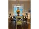 Cozy breakfast nook with a round table, three chairs, and lots of natural light coming through French doors at 625 Huiet Dr, Mcdonough, GA 30252