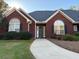 Inviting brick home featuring a well-lit walkway to the front door at 625 Huiet Dr, Mcdonough, GA 30252