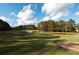 The lush community golf course includes sand traps and a scenic water feature at 625 Huiet Dr, Mcdonough, GA 30252