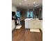 Bright kitchen with white cabinets, stainless steel appliances, and a view into the breakfast nook and backyard at 625 Huiet Dr, Mcdonough, GA 30252
