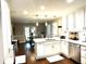 Bright kitchen with white cabinetry, stainless steel appliances, and a view into the dining area at 625 Huiet Dr, Mcdonough, GA 30252